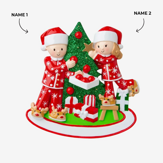 Couple Decorating A Christmas Tree Ornament